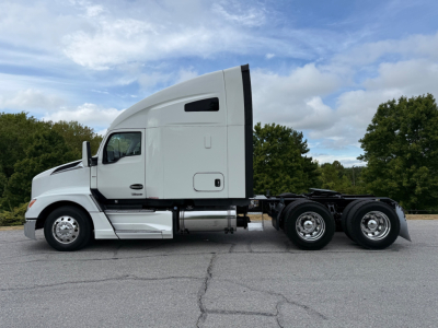 Kenworth T680 tractor in profile view showing sleeper cab, side windows, and dual rear axles with chrome wheels.