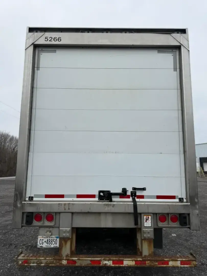 Back view of a refrigerated trailer with roll-up door, metal frame, and rear bumper lights. ID 5266 visible at top left.