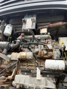 Everest Multi-Temp refrigerated trailer engine bay with visible components: alternator, diesel injection pump, hydraulic lines, coolant filter, wiring, and warning labels.