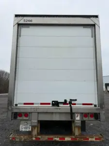 Back view of a refrigerated trailer with roll-up door, metal frame, and rear bumper lights. ID 5266 visible at top left.