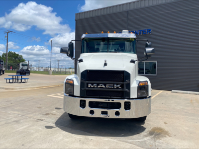 Front view of white 2021 Mack AN64T conventional daycab truck with black grille and chrome bumper.