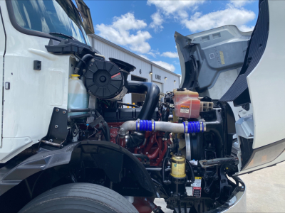 Mack AN64T engine bay view showing intercooler piping and engine components.