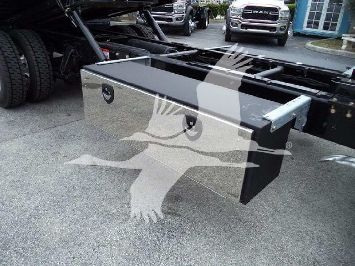 Toolbox side view attached to Freightliner M2 106 chassis showing storage box and mounting hardware.