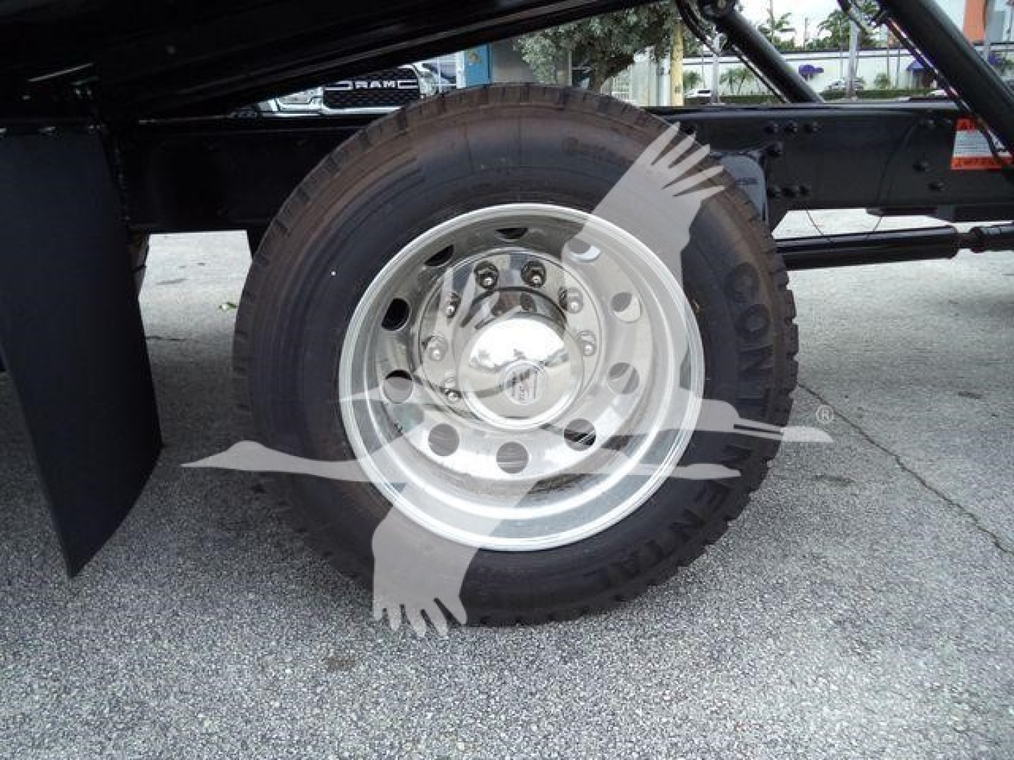Truck wheel and tire assembly showing steel rim and Goodyear tire under Freightliner M2 106 chassis.