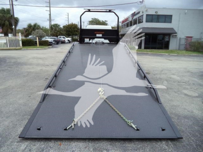 Flatbed tow truck bed with chains secured at corners, 2027 Freightliner M2 106 in New condition, stock JU6168, rollback category.