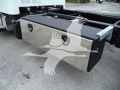 Fuel tank toolbox mounted under Freightliner chassis showing chrome aluminum toolbox with black ends and two circular access ports.