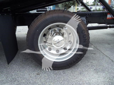Truck wheel and tire assembly showing steel rim and Goodyear tire under Freightliner M2 106 chassis.