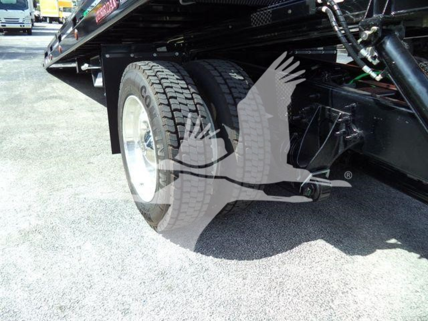 Truck rear undercarriage showing dual rear tires and undercarriage components.
