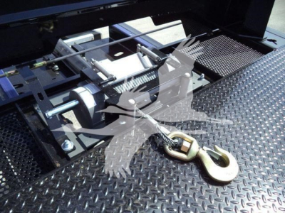 Trailer hitch and platform of a new 2026 International MV truck showing a heavy-duty lashing ring and diamond-plate surface.