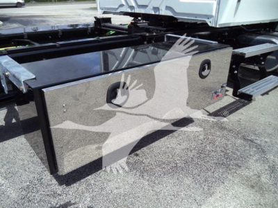Battery box/storage box mounted on truck frame with polished metal surface and circular access panels