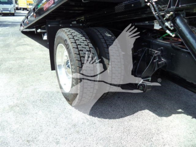 Truck rear undercarriage showing dual rear tires and undercarriage components.