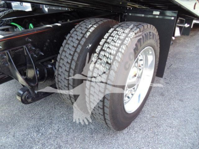 Twin rear tires and suspension of a heavy-duty truck chassis showing Goodyear tires and metal axle components.