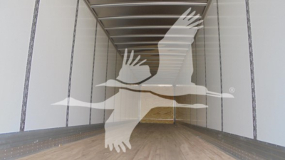 Inside view of empty trailer with overlayed Vanguard logo and birds.