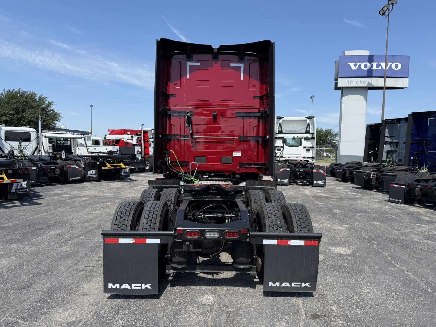 Mack PR64T76H tractor rear view showing fifth wheel, dual rear wheels, and mud flaps with MACK branding.