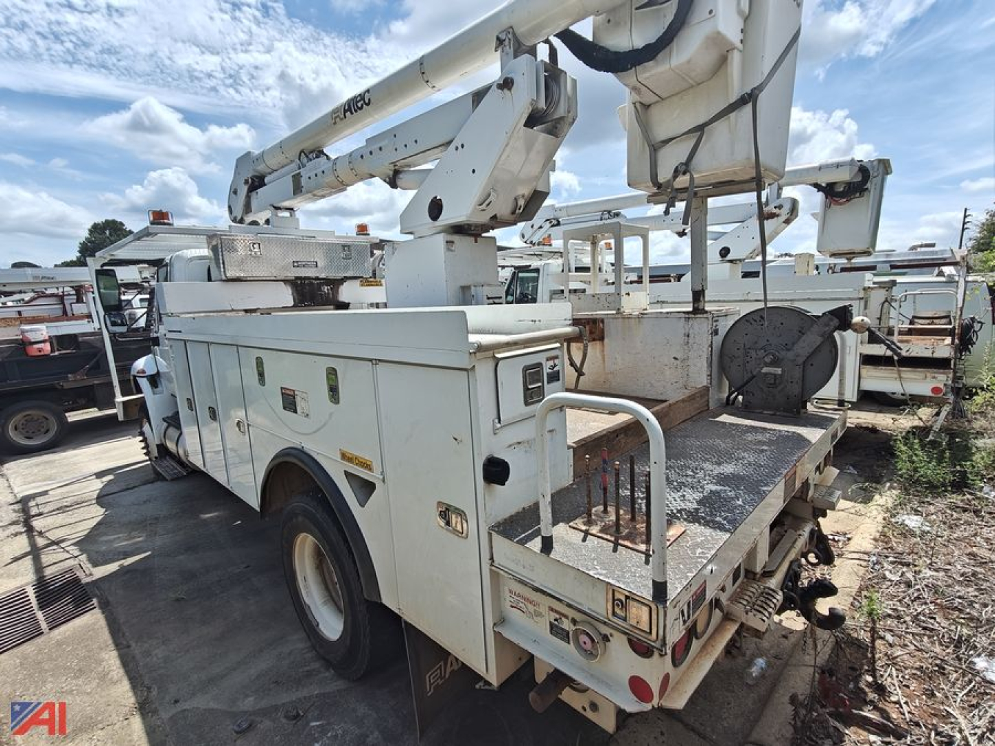 Bucket truck body with boom and hydraulic controls showing utility platform and tool compartments.