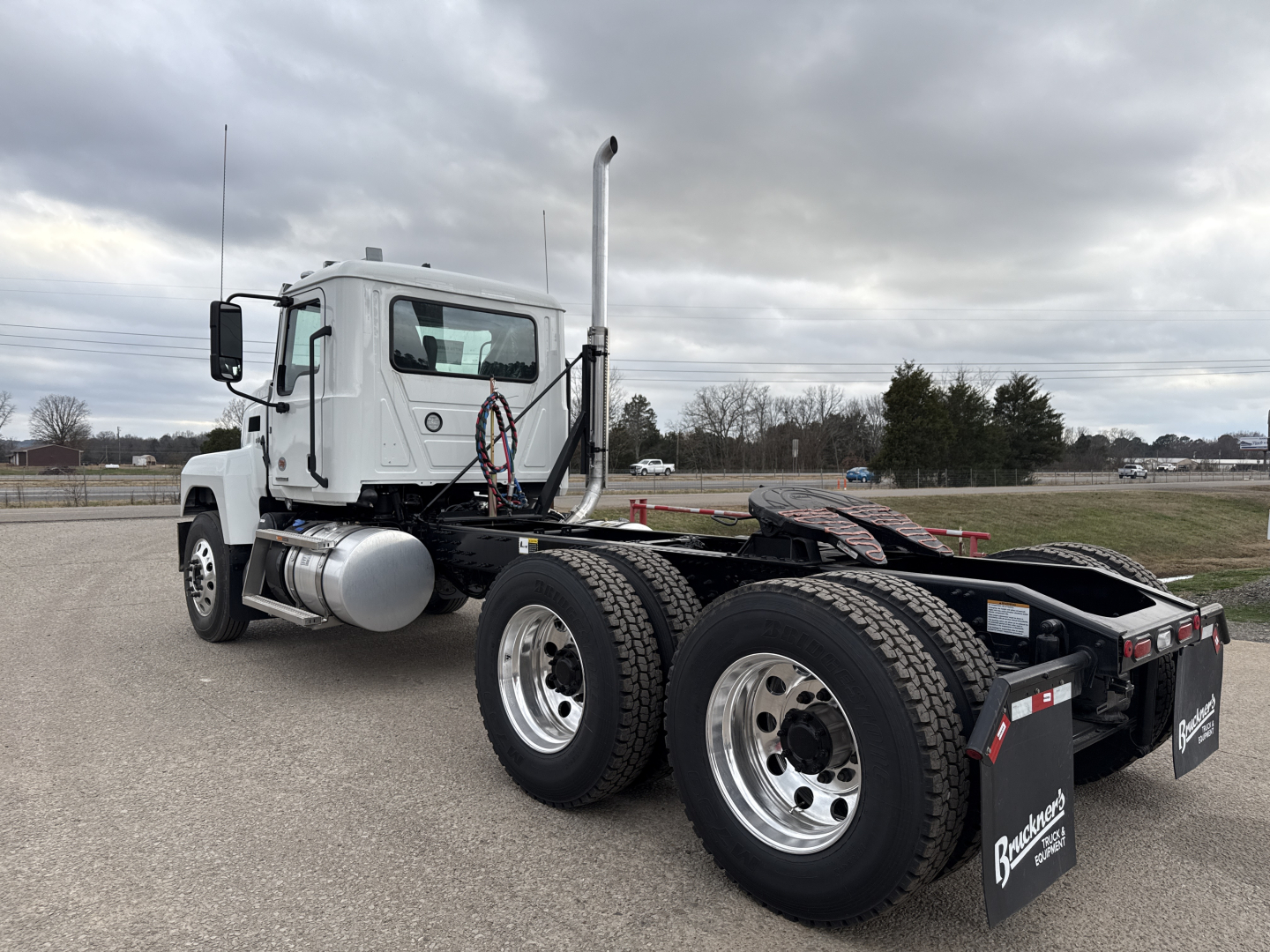 Mack PI64T tractor truck rear cab view showing dual rear axle setup and exhaust stack.