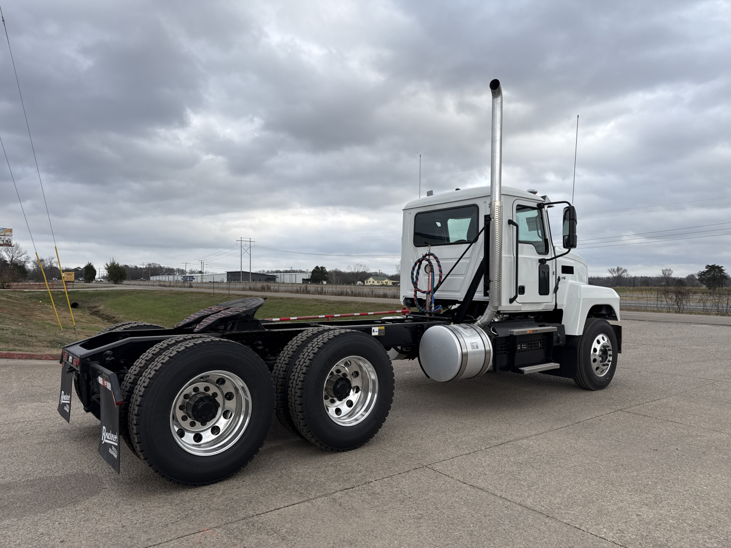 Semi truck chassis and cab showing PI64T with dual rear axles and exhaust stack.