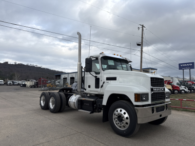 Mack PI64T conventional daycab truck side view showing exhaust stack, front grille, and dual rear axles.