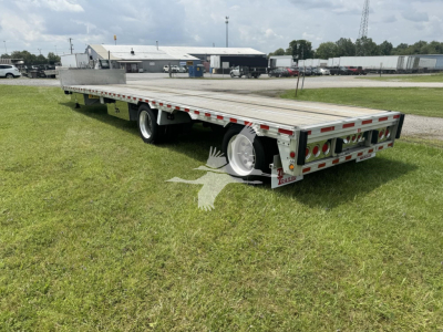 Trailer deck with drop deck design showing aluminum platform, dual rear ramps, and reflective safety tape along the sides.