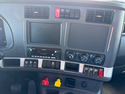 Kenworth T880 dashboard view showing two large blank screens, climate controls, switches, and hazard button.</br>No visible engine or external text.