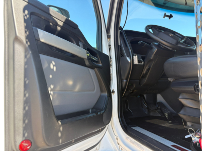 Kenworth T880 truck interior showing open driver door and cab entry with seats and steering wheel.
