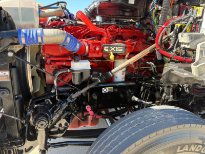 Kenworth T880 engine bay showing Cummins X15 engine and surrounding hoses and components.