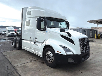 Volvo VNL 760 truck cab in view showing side and front, front grille, headlights, and wheels.