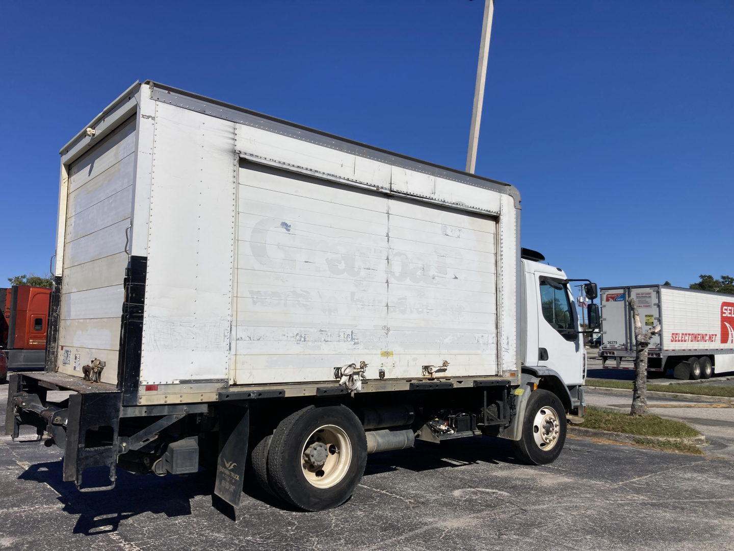 Truck cabover in-service showing cargo box with rear access and dual rear wheels.