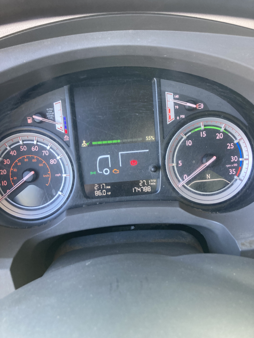 Peterbilt 220 dashboard showing tachometer, speedometer, and digital display with gear indicator and fuel/economy readouts.