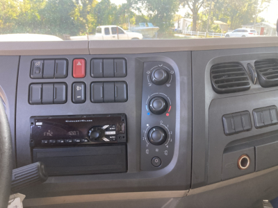 Peterbilt cab interior dashboard controls and radio displaying various knobs and vents.