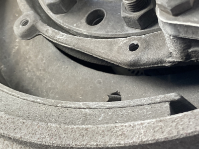 Hub and wheel assembly close-up on a Peterbilt 220 truck showing metal rim, lug nut studs, and circular bearing area.