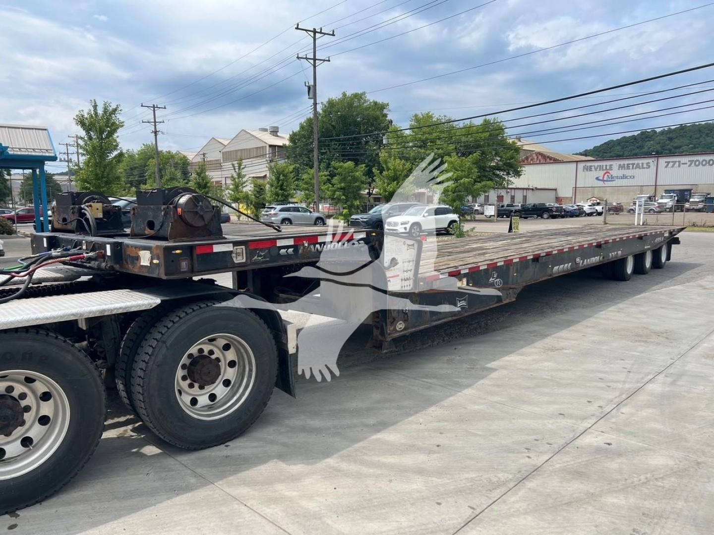 2018 Landoll 455A-53 trailer loaded on a long multi-axle flatbed with dual rear wheels. Visible text includes Landoll branding on the side and trailer components.