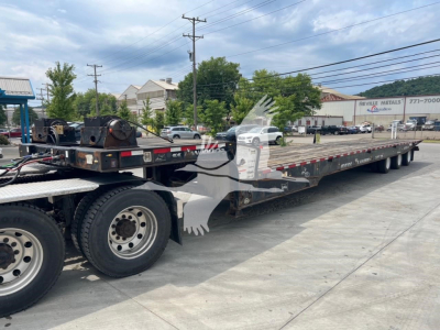 2018 Landoll 455A-53 trailer loaded on a long multi-axle flatbed with dual rear wheels. Visible text includes Landoll branding on the side and trailer components.