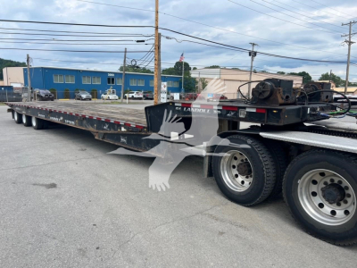 Landoll 455A-53 trailer showing long flatbed with dual rear axles and wheel hubs, stock number 7531, VIN 1LH455WJ2J1A25396 visible in listing.