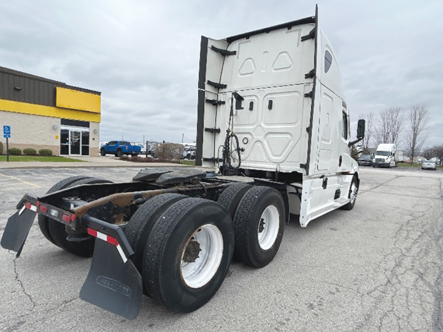 Truck chassis view of a 2020 Freightliner Cascadia126 sleeper with rear wheels and mudflaps visible.