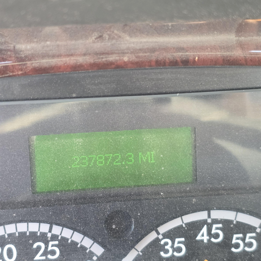 Vehicle instrument cluster showing odometer reading 237872.3 miles on a Freightliner dashboard.