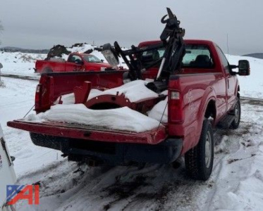 Ford F-350 Super Duty pickup with snow plow attachment in rear bed, red truck, winter scene.