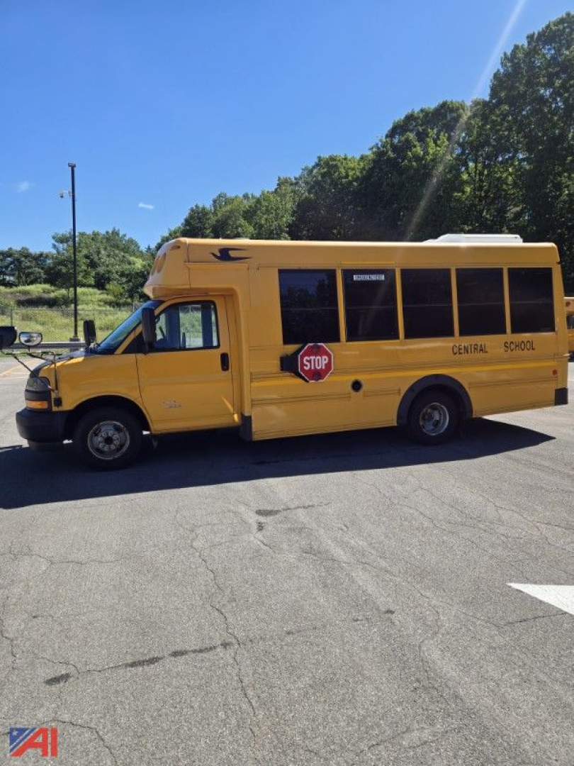 School bus side view showing yellow Chevrolet Express G4500 mini bus with Central School text and stop sign on door.