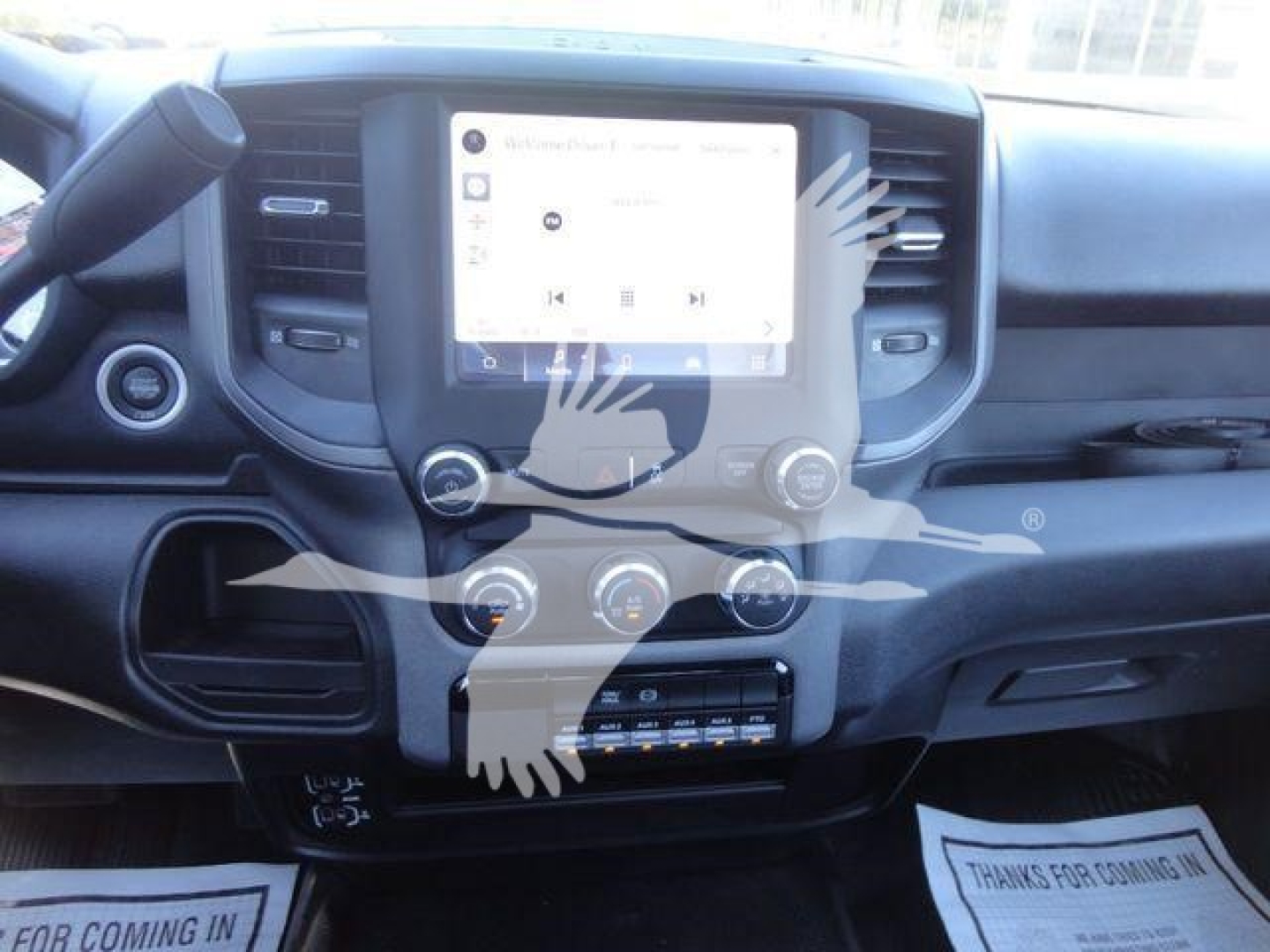 Ram 5500 dash and center infotainment touchscreen showing controls and climate dials.
