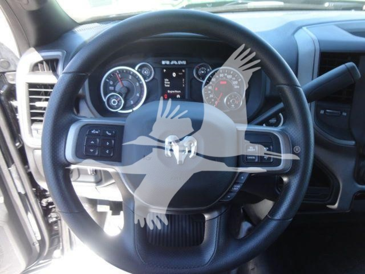 Ram 5500 dashboard and steering wheel inside a pickup truck showing instrument cluster and steering wheel controls.