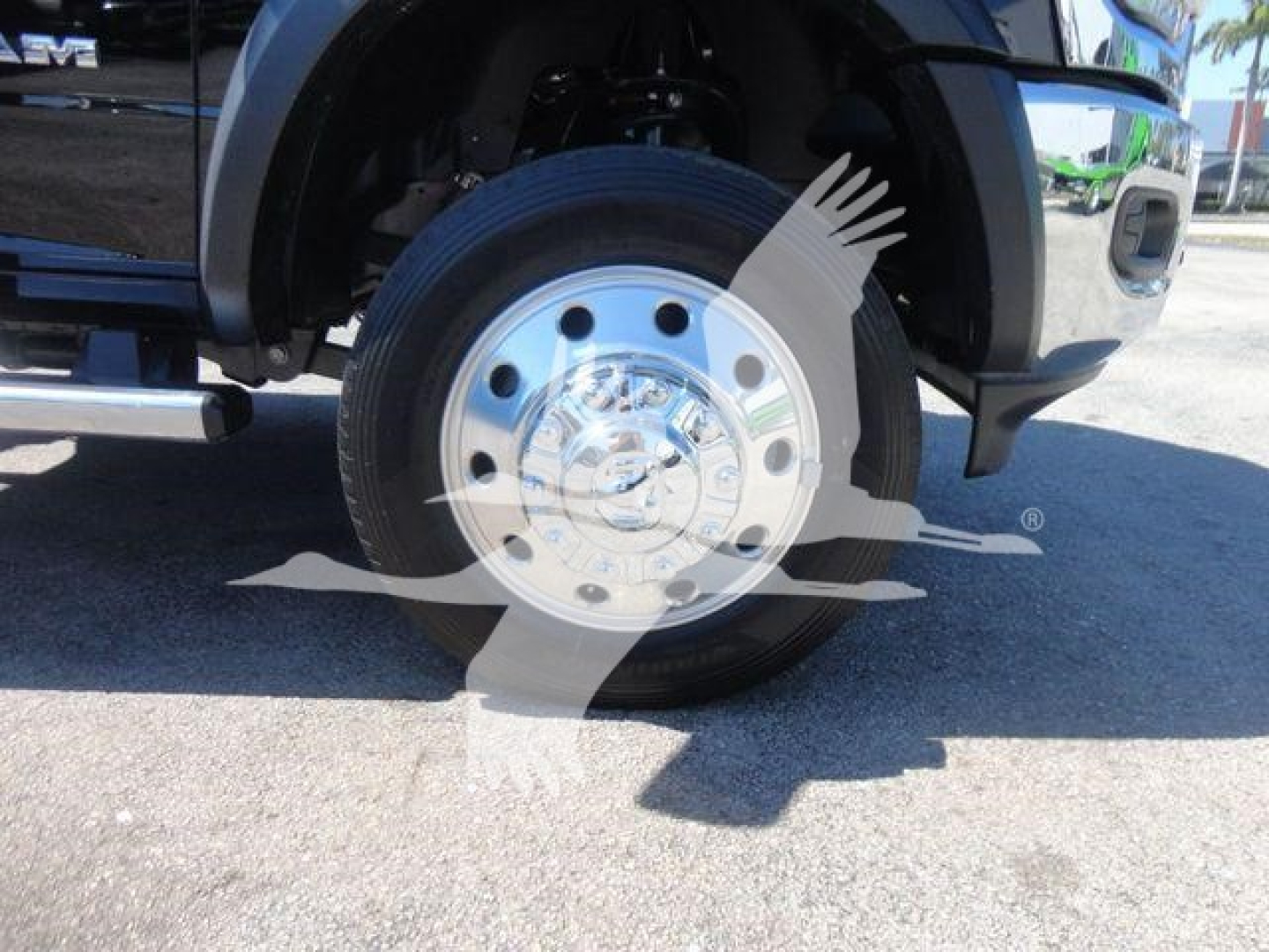 Ram 5500 front wheel and chrome hubcap showing wheel and tire with vehicle fender and side step visible