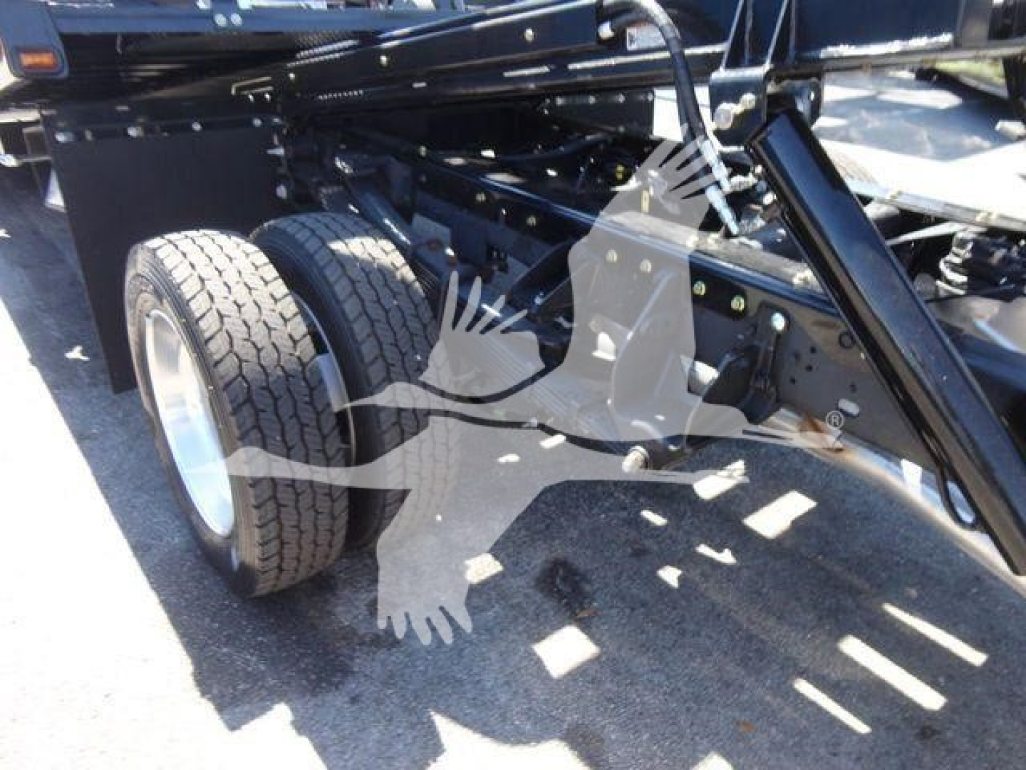 Ram 5500 rollback truck chassis showing dual rear wheels and undercarriage framing with hydraulic components.