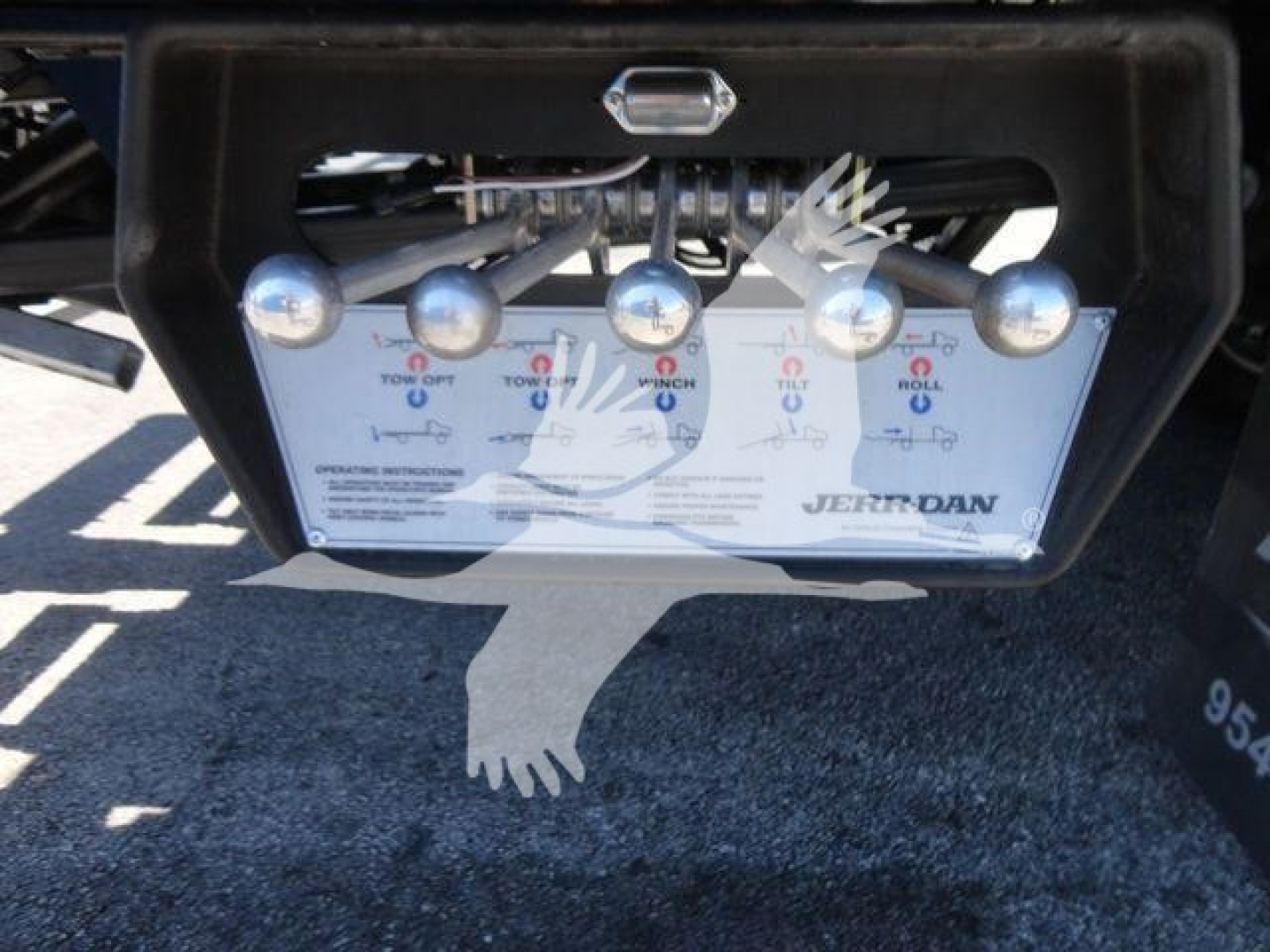 Control panel with multiple levers on a Ram 5500 rollback truck, showing labels and lettering including ‘Jerr-Dan’ at bottom right.