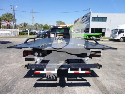 Ram 5500 rollback tow truck flatbed from rear showing rear lights and towing equipment