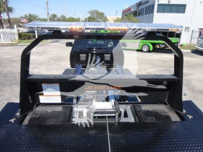 Ram 5500 rollback truck bed with winch and hydraulic system, flatbed diamond plate; rear view showing Jerr-Dan equipment mounting.