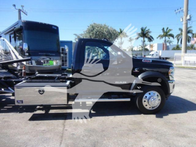 Ram 5500 rollback truck side view showing chrome toolbox and Dually wheel details with black cab and silver accents.