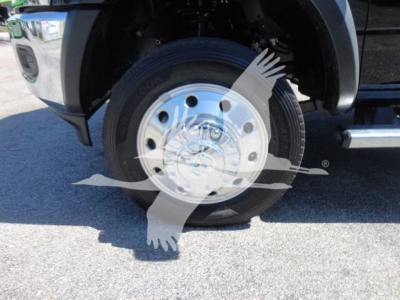 Ram 5500 SLT wheel close-up showing steel wheel with chrome hubcap and tire sidewall text visible.