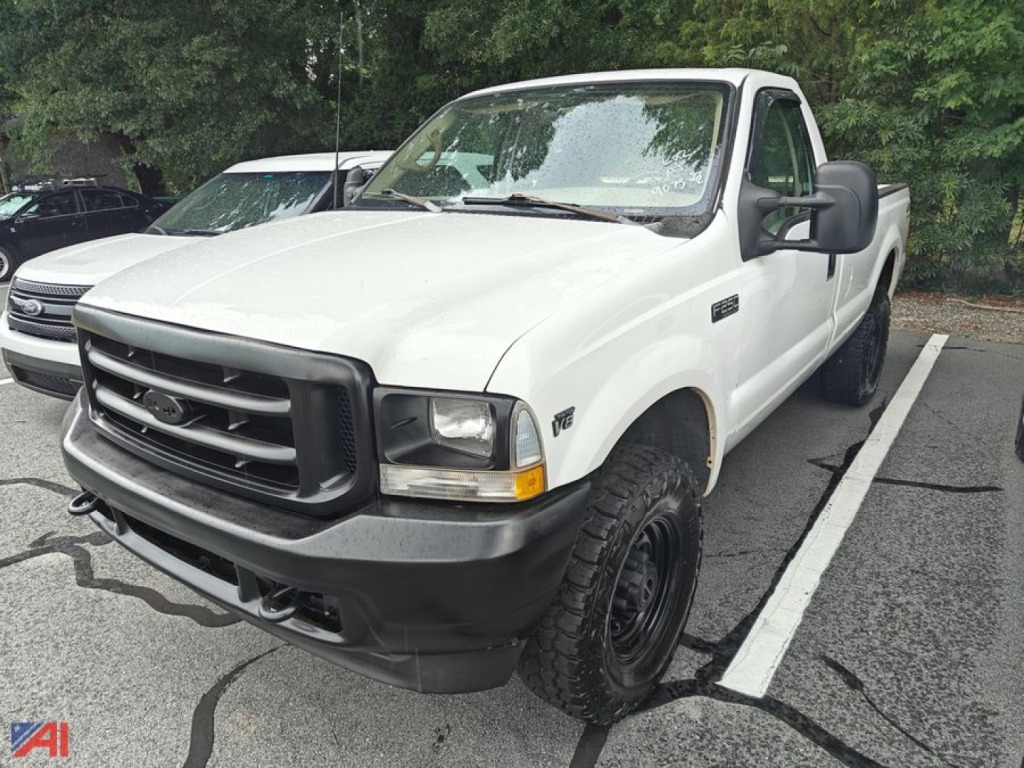 White 2002 Ford F-250 pickup truck in a parking lot, front-left view, with black bumper and large tires.