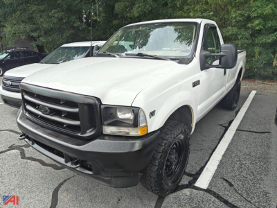White 2002 Ford F-250 pickup truck in a parking lot, front-left view, with black bumper and large tires.