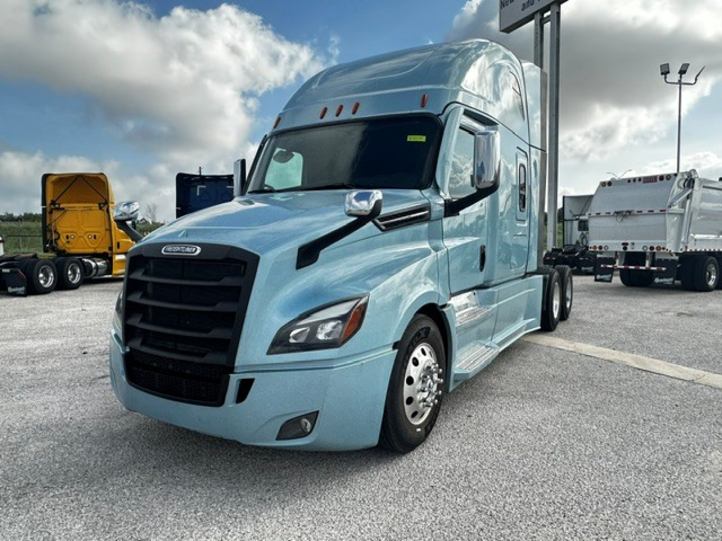 Freightliner Cascadia 126 tractor in light blue, front-left view, with sleeper cab and chrome mirrors.